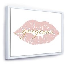 a pink and gold lip print on a white wall