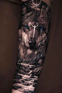 a wolf tattoo on the arm with blue eyes