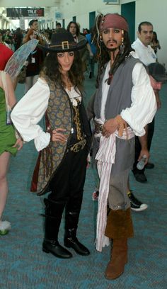 two people dressed up as pirates at an event