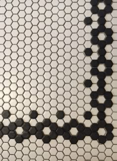 a black and white tiled wall with hexagonal tiles