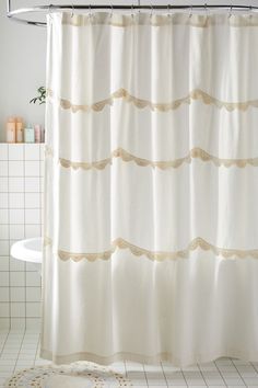 a white shower curtain in a bathroom