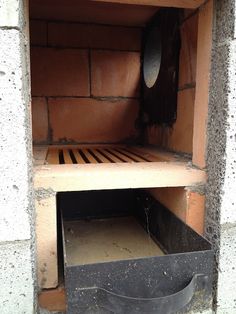 a wooden shelf with a metal bin in it