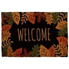 a welcome mat with leaves on it