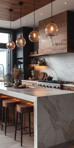 a modern kitchen with marble counter tops and stools in front of an open window