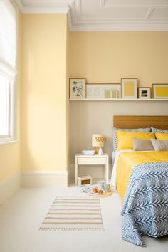 a bedroom with yellow walls and white carpet