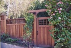 a wooden gate surrounded by greenery and flowers