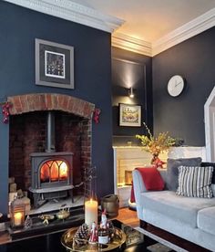 a living room filled with furniture and a fire place next to a wall mounted clock