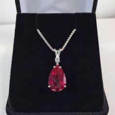 "Beautiful Ruby & White Sapphire Pendant Necklace * Pear Cut Ruby Measures 12mm x 8mm * Single Brilliant Cut White Sapphire Accent * 4cts Total Gemstone Weight * 16\" or 18\" Sterling Silver Chain Included * Solid Sterling Silver - Also available in 14kt Gold (message me for details) Hallmarked & Gift Ready! Matching Earrings & Ring Available This Gorgeous Ruby is laboratory grown. It is identical to the natural stone in every way, including chemistry, composition and hardness, with Formal Hallmarked Teardrop Necklace, Formal Teardrop Gemstone Necklace, Fine Jewelry Pear-shaped Drop Necklace As Gift, Classic Hallmarked Pear-shaped Necklace, Fine Jewelry Pear-shaped Drop Necklace For Gift, Formal Teardrop Pendant Drop Necklace With Gemstone, Pear-shaped Fine Jewelry Drop Necklace For Gift, Classic Teardrop Hallmarked Necklaces, Anniversary Teardrop Gemstone Drop Necklace