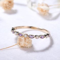 a close up of a ring on a table with flowers and petals in the background