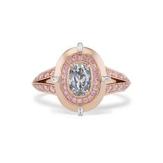 Crafted with precision, this ring features rare Argyle Pink™ diamonds harmoniously paired with a shimmering gray diamond, set against a backdrop of gleaming rose gold. The contrast between the soft pink tones and the smoky hues creates a striking visual harmony, making this ring a standout piece for any occasion. 0.53CT Cushion Fancy Light Gray - GIA #1152520880 0.56CT Brilliant Round Argyle Pink Diamonds (6PR/7PR) 0.04CT Brilliant Round Natural White Diamonds 18KT White and Rose Gold Handcrafted Size: 6.5 Luxury Brilliant Cut Pink Gold Diamond Ring, Luxury Pink Gold Diamond Ring With Brilliant Cut, Luxury Pink Diamond Ring With Single Cut Diamonds, Luxury Pink Diamond Ring With Halo Design, Luxury Rose Cut Diamond Ring In Rose Gold, Luxury Rose Gold Diamond Ring With Rose Cut, Luxury Pink Halo Diamond Ring, Luxury Pink Rose Cut Diamond Wedding Jewelry, Pink Gold Diamond Ring With Brilliant Cut