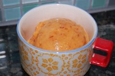 a cup filled with food sitting on top of a counter