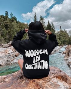 Retro Women In Construction Unisex Hoodie. This cozy sweatshirt is the perfect gift for the construction worker in your life. Show your love for trades with this groovy back print design! For an oversized look please size up! Our hoodies are standard unisex sizes so please check the size chart! This unisex heavy blend hooded sweatshirt is relaxation itself. Made with a thick blend of cotton and polyester, it feels plush, soft and warm, a perfect choice for any cold day. In the front, the spacious kangaroo pocket adds daily practicality while the hood's drawstring is the same color as the base sweater for extra style points. Gildan Brand Hoodie .: 50% cotton, 50% polyester .: Medium-heavy fabric (8.0 oz/yd² (271 g/m .: Classic fit .: Tear-away label .: Runs true to size Estilo Hipster, Ayat Alkitab, Aesthetic Hoodie, Milk Silk, Hipster Fashion, Jesus Saves, Rock Climbing, Fabric Names, Lacrosse