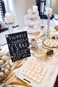 a table filled with desserts and cupcakes on top of eachother