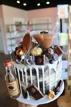 a cake with chocolates, marshmallows and other toppings on it