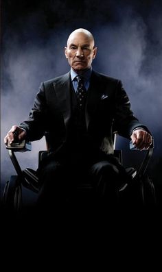 a man in a suit and tie sitting on a chair