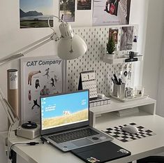 a laptop computer sitting on top of a white desk