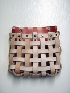 a woven purse hanging on the wall