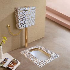 a lamp that is sitting on the ground next to a magazine holder and flower vase