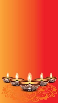 three lit candles with intricate designs on an orange and red background for diwaling