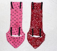 two pink and red ties with black polka dots on them sitting next to each other