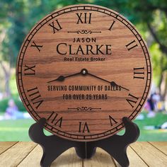 a wooden clock with the words, mason clarke real estate broker serving community of dails for over 25 years