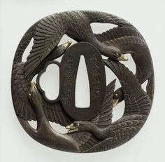 a metal belt buckle with two birds and an o - ring on the center, in front of a white background