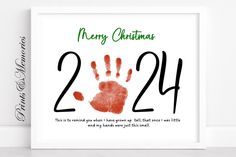 a christmas card with the number twenty four and handprinted red hands on it