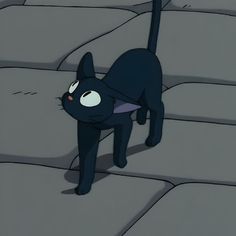 a black cat standing on top of a stone floor