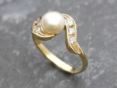 Gold Vintage Pearl Ring set with a Natural Pearl at size 8mm (AAA Grade) from Japan.Gold Vermeil: 18k Gold over Solid 925 Sterling Silver ☞ made to last. Click here for ☞ Matching EarringsMatching Pendant - please ask me Details:• Natural Pearl sourced from Japan• Pearl: 8mm, AAA Grade• Dimensions: Band width ≈ 2.5mm, thickness ≈ 1.5mm• 18K Gold Vermeil❀ Each Natural Gem is unique & will have Slight variations from the product pictures "no two Natural Stones are alike"SKU 2269 Pearl Ring Designs Unique, Gold Antique Ring, Pearl Ring Design, Vintage Pearl Ring, Natural Pearl Ring, Pearl Rings Vintage, Ring Pearl, Pearl Rings, Gold Pearl Ring