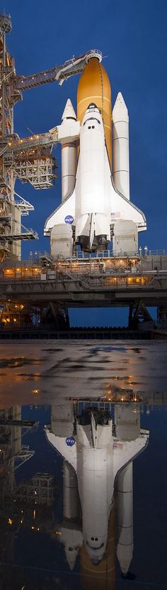 the space shuttle is parked on top of a building