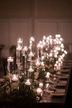 a long table with candles and flowers on it