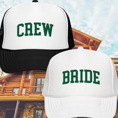 two hats with the words crew and bride printed on them in front of a log cabin