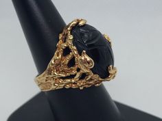 Accessorize any outfit with this stunning 10kt gold and onyx ring. The intricate black onyx stone is the perfect accent to the flowing yellow gold. At a ring size of 7 3/4, this ring is comfortable for all-day wear. The stone is carved on both the top and the underside. the ring features a primal molten flow design that looks quite captivating. Buy with confidence the item is as described, if you have any questions please do not hesitate to ask. Elegant Carved Signet Ring For Formal Occasions, Elegant Carved Rings For Formal Occasions, Black Oval Filigree Ring For Formal Occasions, Black Cabochon Signet Ring For Formal Occasions, Antique Black Filigree Ring For Formal Occasions, Formal Black Cabochon Signet Ring, Black Cabochon Ring In 14k Gold, Black Filigree Ring With Intricate Design For Formal Occasions, Black 14k Gold Cabochon Ring