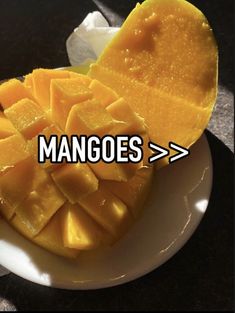 mangoes on a white plate with the words mangoes above it and an arrow pointing to them