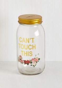 a glass jar with gold lid that says, can't touch this on it