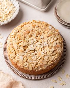 a cake covered in almonds sitting on top of a table