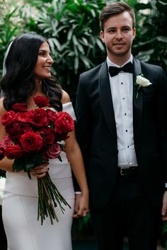 a bride and groom standing next to each other