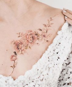 a woman's chest with flowers on it