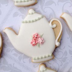 decorated cookies in the shape of teapots with flowers