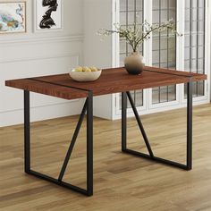 a wooden table with metal legs and a bowl of fruit on it