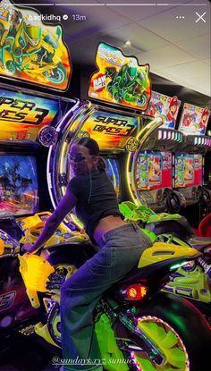 a man riding on the back of a motorcycle next to slot machines in a casino