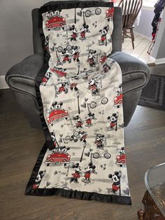 the mickey mouse blanket is on top of a chair