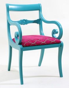 a blue chair with a pink cushion on it's back and armrests