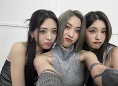 three young women are posing for the camera