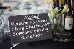 there is a sign that says alcohol because no great story started with someone eating a salad