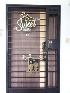 the front door to home sweet home is decorated with gold and black letters on it