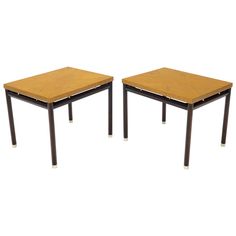 a pair of tables with metal legs and wooden tops