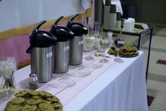 the table is set up with cookies and drinks for guests to enjoy their desserts