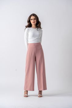 DESIGNED WITH YOU IN MIND Ameera Modest Wear is proud to offer our Milano Palazzo pants. If you enjoy the classic look of palazzo pants, youʼll love this modern take. Featuring a high-rise waist and wide-angled cut. The Milano Palazzo pants help achieve the appearance of a small waist and long legs. These womenʼs palazzo pants are perfect for day-time or evening wear. Specifications: Color: Blush Pink - Rosie Beige Non-stretchy material Features a zipper and hook in the back Model is 5'11" and i Elegant Wide-leg Culottes With Elastic Waistband, Elegant Wide Leg Culottes With Elastic Waistband, Versatile Wide-leg Spring Dress Pants, Spring Wide Leg Dress Pants, Versatile Wide Leg Spring Dress Pants, Spring Wide Leg Versatile Dress Pants, Elegant High-waist Wide Leg Pants With Elastic Waistband, Elegant High Waist Wide Leg Pants With Elastic Waistband, Loose Fit Wide Leg Dress Pants