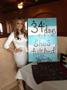 a woman standing next to a sign that says 31 days she's hitched